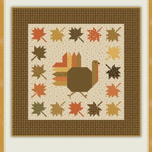 May include: A quilt pattern titled Autumn Hues #857 by Sandy Gervais from Pieces From My Heart. The design features a central turkey surrounded by a border of various maple leaves in shades of orange, yellow, brown, and cream on a dark background.