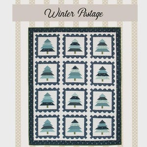 May include: A fabric panel featuring a quilt design with a winter theme. The quilt has a repeating pattern of stylized blue-green Christmas trees within square frames. The words "Winter Postage" are at the top, with "Lamb Farm Designs" and "Made in the USA" at the bottom.