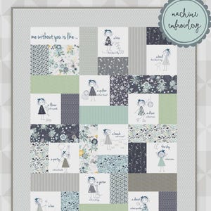 May include: A patchwork quilt with a gray border, featuring various fabric patterns and illustrations of a girl with text. The text includes phrases like "me without you is like..." and "machine embroidery". The quilt is signed "meags & me".