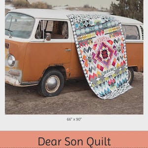 May include: A colorful quilt, 66 x 90 inches, draped over a vintage orange and white van. The quilt features geometric patterns, text, and a central diamond design. The text on the quilt reads "LET YOUR SOUL & SPIRIT FLY".