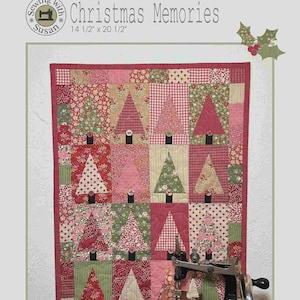 May include: A Christmas-themed quilt with tree designs in red, pink, and green fabrics. The quilt measures 14.5 x 20.5 inches. A vintage Singer sewing machine and small decorative trees are in the foreground. The text "Christmas Memories" is visible.