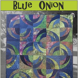May include: A handmade quilt with a geometric design featuring blue, green, and gold fabrics. The quilt has a repeating pattern of curved shapes and squares. The text "BLUE ONION" is at the top, and "Saginaw St Quilts" is at the bottom.