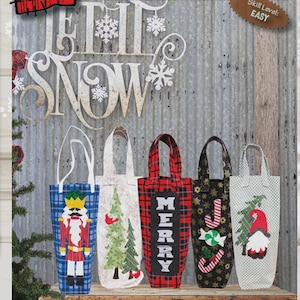 May include: Holiday-themed wine totes with various designs, including a nutcracker, Christmas tree, and gnome. The totes are in different colors and patterns, with the word "MERRY" on one. The text "WINE TOTES HOLIDAY EDITION" is visible.
