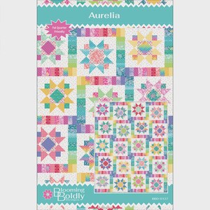 May include: A quilt pattern titled Aurelia by Blooming Boldly Designs featuring a colorful star block design. The pattern includes a star-themed quilt layout with pink, yellow, teal, and purple fabric swatches, a Fat Quarter Friendly label, and the text BBD-0127.