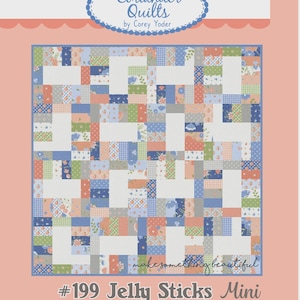 May include: A quilt pattern titled "#199 Jelly Sticks Mini" by Coriander Quilts. The quilt design features a patchwork of rectangular and square fabric pieces in shades of blue, green, orange, and gray, with floral and geometric patterns. The background is a light peach color.