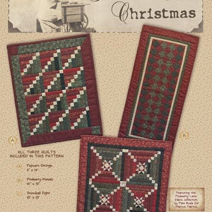 May include: A sewing pattern titled Pineberry Christmas featuring three quilts: Popcorn Strings 11" x 14", Pineberry Mosaic 14" x 31", and Snowball Fight 15" x 15". The quilts use red, green, and cream fabrics in geometric patchwork designs.