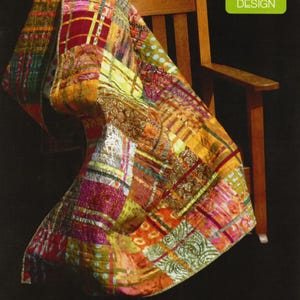 May include: A colorful patchwork quilt draped over a wooden chair. The quilt features a variety of fabrics in shades of red, orange, yellow, and green. The text "CRANBERRY CHUTNEY" is at the bottom of the image. A green square with a chair graphic and "MADISON COTTAGE DESIGN" is in the upper right.