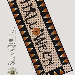 May include: A Halloween-themed runner with the word "HALLOWEEN" in large, black letters. The runner is 17 x 47 inches, featuring a cream-colored background with black and orange accents, including a pumpkin design and triangle patterns.