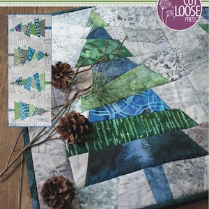May include: A quilt pattern titled Crazy Christmas Trees designed by Karla Alexander. The cover features a blue and green pieced tree design, three pinecones, and text stating 16.5 inches by 43.5 inches, 2-6 hours, and Square Friendly.
