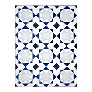 May include: A white and blue Santorini quilt with a geometric star pattern. The quilt features a repeating design of light blue and dark blue shapes on a white background. The text "SANTORINI QUILT" is at the top, with "BEGINNER" and size options at the bottom.