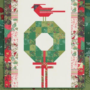 May include: A quilt pattern titled Cardinal's Christmas Wreath by Robin Pickens. The design features a central green patchwork wreath topped with a red cardinal bird, flanked by vertical borders of floral and bird-themed fabric squares.