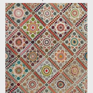 May include: A colorful quilt titled "Star Upon Stars" with a repeating pattern of star and floral designs. The quilt is 64" x 74" and features a variety of colors including pink, green, red, and brown. The quilt is made by Laundry Basket Quilts.