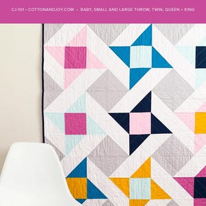 May include: A colorful quilt with a geometric star pattern in shades of pink, blue, yellow, and gray. The quilt is displayed on a wall, with the text "MIGHTY STARS" at the top. The quilt is made of cotton and is available in various sizes.