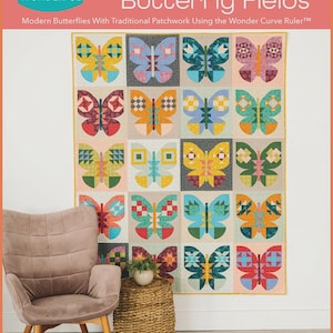 May include: A colorful quilt featuring a butterfly design. The quilt is made with traditional patchwork techniques and features a variety of colors, including blue, yellow, red, and green. The text "Butterfly Fields" is displayed at the top.
