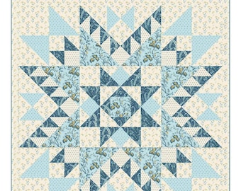 May include: A quilt pattern titled "True North Beach House" by Laundry Basket Quilts. The quilt design features a central starburst pattern in shades of blue and cream, with floral and geometric elements. The quilt size is 64.5 inches by 64.5 inches.