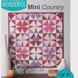 May include: A colorful quilt pattern titled "Mini Country" with a floral design in shades of pink, purple, and burgundy. The quilt measures 20 x 20 inches. The text "Sew Kind of Wonderful" is at the top left.