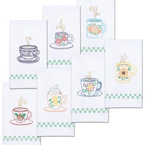 May include: White kitchen towels with embroidered coffee cup designs. Each towel features a different colorful floral or patterned coffee cup with steam rising. A green and white cross-stitch border accents the bottom of each towel.