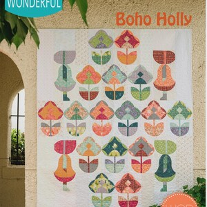 May include: A large, square quilt with a repeating floral pattern in shades of orange, green, pink, and teal. The quilt is labeled "Boho Holly" and "WCR Pattern". The brand "Sew Kind of Wonderful" is also visible.