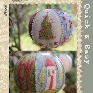 May include: Two handmade Christmas baubles with embroidered designs. One features a green Christmas tree with red garland, the other says "JOY" and has a house and trees. The text "Joyful Xmas Bauble" is at the bottom.