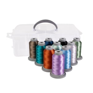 May include: A clear plastic storage box with a handle, containing 10 spools of colorful embroidery thread. The spools are arranged in a semi-circle, with the colors ranging from brown to teal to purple to blue.