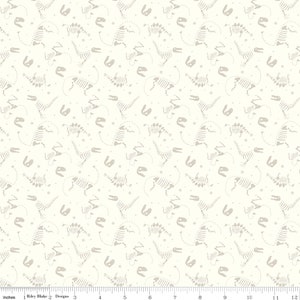May include: White fabric with a repeating pattern of gray dinosaur skeletons. The skeletons are in various poses, including standing, walking, and running. There are also small gray circles scattered throughout the fabric.