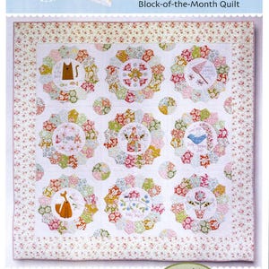 May include: A quilt with a floral pattern and the text "Beyond the Porch." The quilt features circular designs with various illustrations, including a cat, a bird, and a fox. The Birdhouse Patchwork Designs logo is at the bottom.