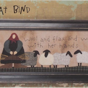 May include: Framed embroidery with a rustic design. The artwork features a woman, sheep, and text that reads "She seeketh willingly" and "Wool and flax and worketh with her hands." The frame measures 7" x 32".