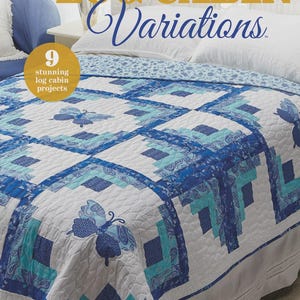 May include: A quilt with a Log Cabin design in shades of blue and white, featuring butterfly appliqués. The quilt is on a bed with white pillows and a patterned bedspread. The cover of the book "Log Cabin Variations" is visible.