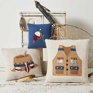 May include: Three decorative fishing-themed pillows. One pillow features a fishing vest design, another a fishing hat, and the third a bobber. The pillows are approximately 9 inches by 9 inches, 5.5 inches by 5.5 inches, and 7 inches by 8.25 inches.