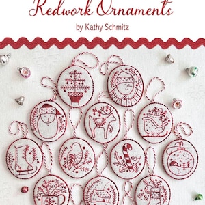 May include: A collection of redwork Christmas ornaments with various festive designs, including a Christmas tree, Santa Claus, and a reindeer. The ornaments are round, with red embroidery on a cream background, and are strung with red and white twine. The text "JOLLY & BRIGHT" is at the top.