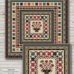 May include: Amelia quilt pattern by Nancy Rink Designs. The quilt features a central floral design in a vase, surrounded by star and geometric patterns in shades of red, teal, and brown. Finished quilt sizes are 51 x 51 inches and 98 x 98 inches.