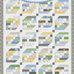 May include: A patchwork quilt with a repeating geometric pattern. The quilt features various fabric squares in shades of blue, yellow, green, and gray. The quilt is labeled "Coriander Quilts by Corey Yoder" and "#172 Crosswinds".