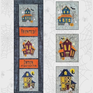 May include: A Halloween-themed fabric panel featuring three wonky houses with orange and purple accents, bats, ghosts, and pumpkins. The panel includes the text "HAUNTED!" and "ENTER at your own risk". The design is by Bruce Allen Designs.