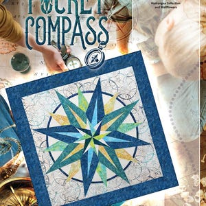 May include: A quilt pattern titled "Pocket Compass" featuring a starburst design in shades of blue, green, and yellow. The quilt is framed with a dark blue border. The image includes the text "Timeless Treasures" and "Quiltworx.com".
