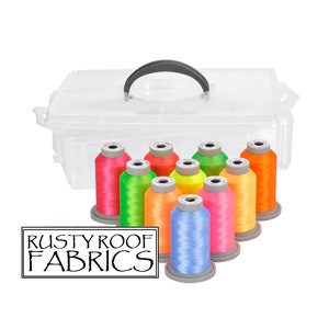 May include: A clear plastic storage box with a handle, containing 10 spools of neon colored embroidery thread. The spools are arranged in a semi-circle and the box is sitting on a white background. The text "RUSTY ROOF FABRICS" is printed in black on a white rectangle below the box.