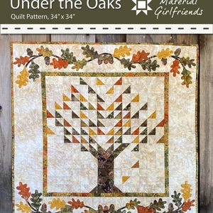 May include: A quilt pattern titled "Under the Oaks" featuring a tree design. The quilt measures 34 x 34 inches and has a cream background with a tree made of triangles in shades of brown, orange, and yellow. The border has oak leaves and acorns.