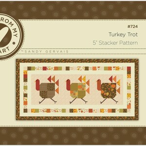 May include: A quilt pattern titled Turkey Trot #724 5" Stacker Pattern by Pieces From My Heart and Sandy Gervais. The design features three stylized turkeys in brown, orange, and green tones, surrounded by a border of small patchwork squares.