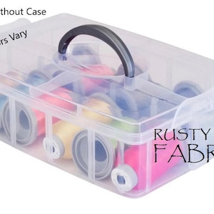 May include: A clear plastic sewing kit organizer with a black handle, filled with colorful spools of thread. The text "Rusty Roof Fabrics" is visible on the side. The text "With Or Without Case" and "*Kit Colors Vary" are also visible.
