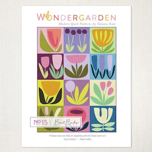 May include: A print titled "WONDER GARDEN" featuring a grid of colorful, stylized floral designs. The print includes the text "Modern Quilt Patterns by Tamara Kate" and "Best Buds No. 15". A quote by Paulo Coelho is also included.