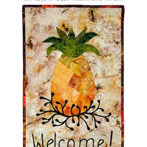 May include: A wall hanging pattern featuring a pineapple design. The pineapple is made of patchwork in shades of orange and yellow, with green leaves. The word "Welcome" is written in black script. The wall hanging measures 13" x 22".