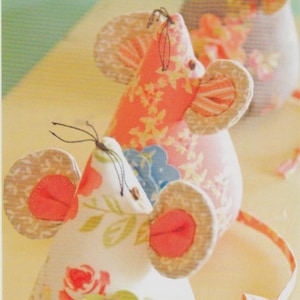 May include: Three fabric mice with floral and patterned designs. The mice have large, round ears and long tails. The text "Three Blind Mice" and "Great to do with kids!" are visible.