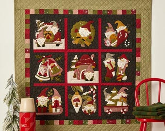 May include: A Christmas-themed quilt featuring nine squares with gnome designs. The quilt is 35 x 35 inches, with a black background and red and green accents. The gnomes are depicted with holiday decorations.