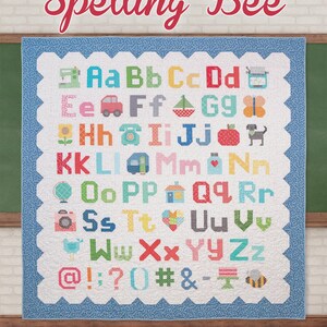May include: A colorful quilt with the words "Spelling Bee" at the top. The quilt features the alphabet with corresponding images for each letter. The quilt has a scalloped edge and a blue border.