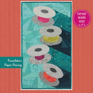 May include: A quilt pattern titled "Bonnie the Bobbin" with dimensions of 16" x 29". The design features stacked, stylized bobbins in various colors against a teal and blue background. The text "Foundation Paper Piecing" is visible, along with "Everyday NOTIONS series 4 of 5".