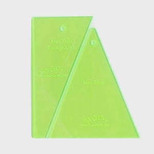 May include: Two neon green quilting templates. One is rectangular and labeled "Mini Tree Background" and the other is triangular and labeled "Mini Tree". Both have the text "SUZN QUILTS... www.SuznQuilts.com".