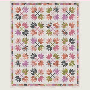 May include: A quilt pattern titled Leaf Pile by Copper Kettle Quilt Company. The design features a repeating block pattern of stylized leaves in shades of pink, green, orange, and black on a white background with a dotted border.