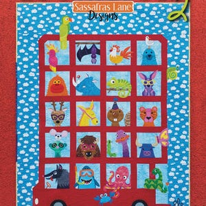 May include: A colorful quilt featuring a red bus filled with whimsical animal characters. The quilt has a blue sky background with white clouds and the word "Zootropolis" at the top. The quilt is designed by Sassafras Lane Designs.