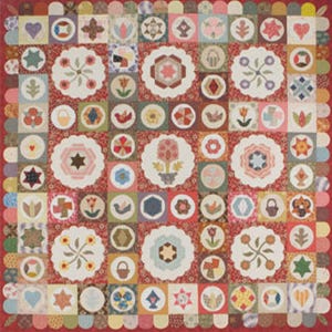 May include: A handmade quilt with a red floral background and various appliqued designs. The quilt features floral, geometric, and heart motifs in a patchwork style. The border is scalloped, adding a decorative touch to the overall design.