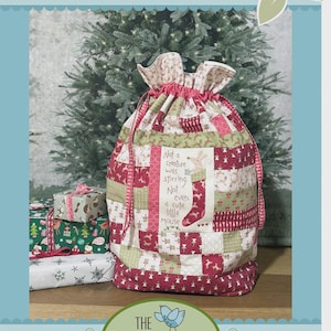 May include: A patchwork Santa sack with a drawstring closure, featuring a mix of red, green, and cream fabrics. The sack has the text "Little Mouse Santa Sack" and a quote about a cute little mouse. The Birdhouse Patchwork Designs logo is at the bottom.