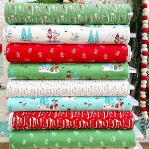 May include: A stack of ten fabric panels with various Christmas-themed prints. The prints feature elves, trees, and stockings. The fabric is a soft, white background with green, red, and blue accents.